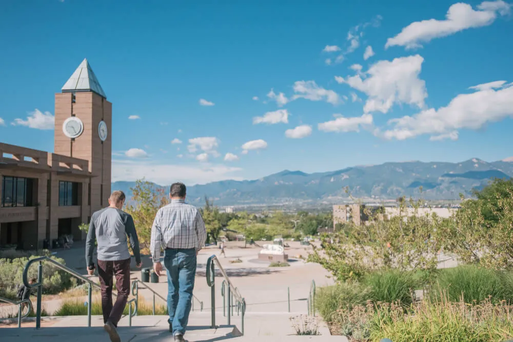 People walking down the steps in front of the Engineering Building. 