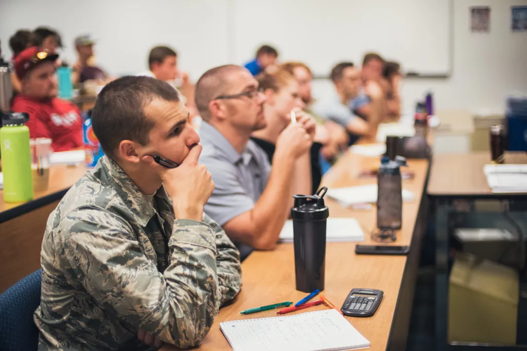 students sitting in a classroom listening to a professor